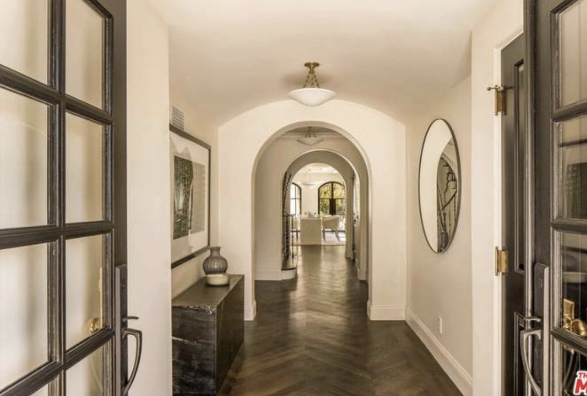 McCadden Residence hallway with herringbone floors and arches