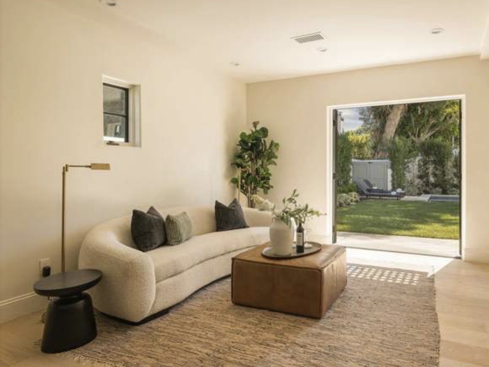 McCadden Residence sitting room with curved sofa and garden views