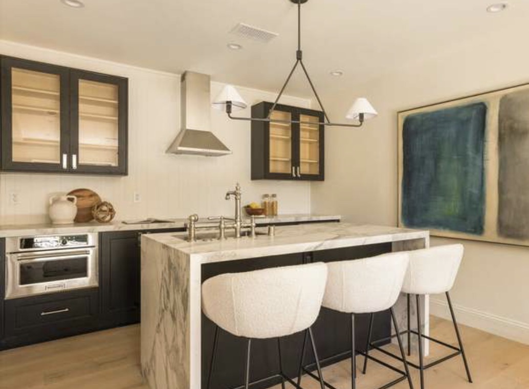 McCadden Residence wet bar with dark cabinets and marble island